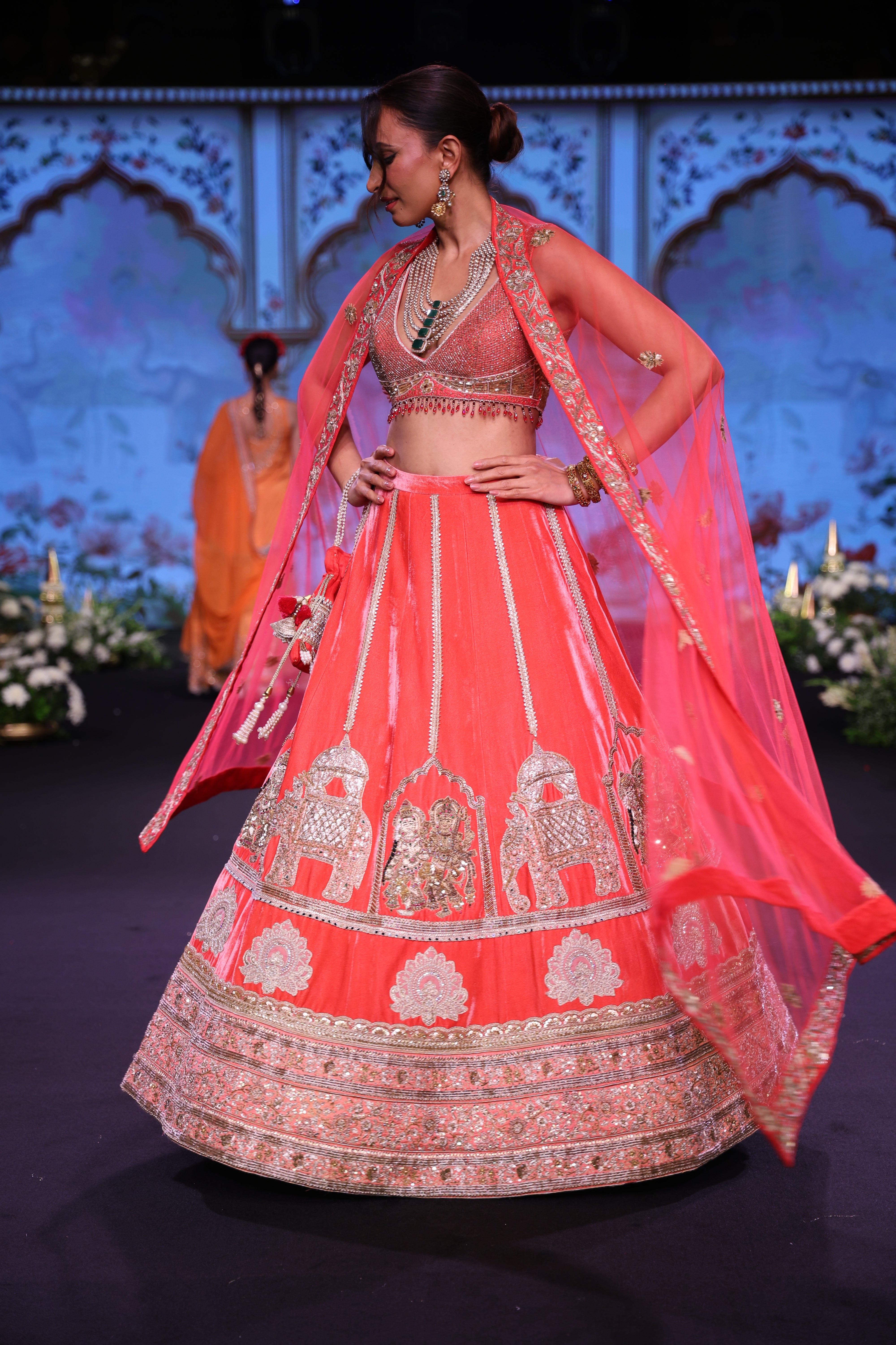 Dark orange lehenga set with embroidered motif and applique work