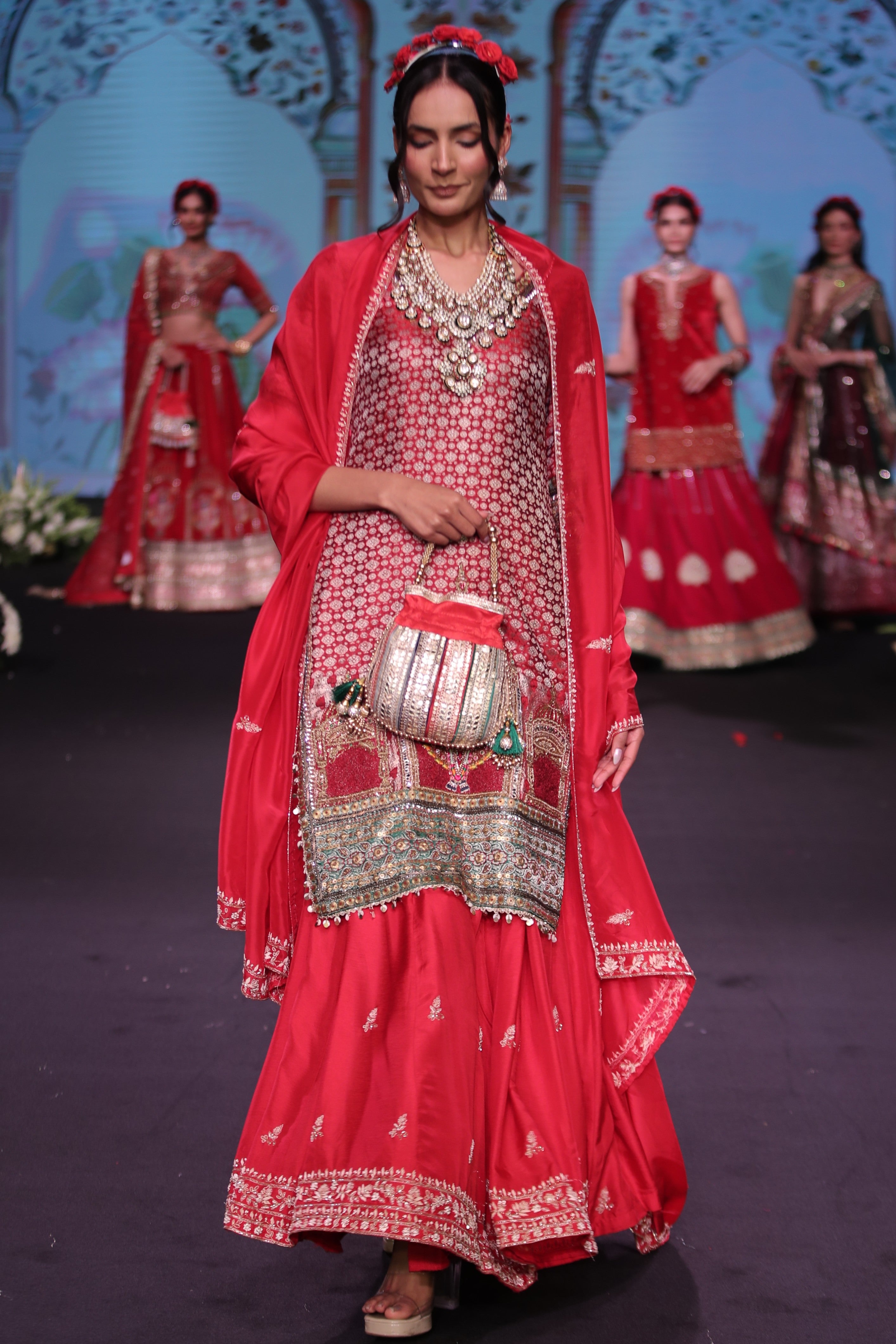 Red embroidered kurta and lehenga set with srinathji motif