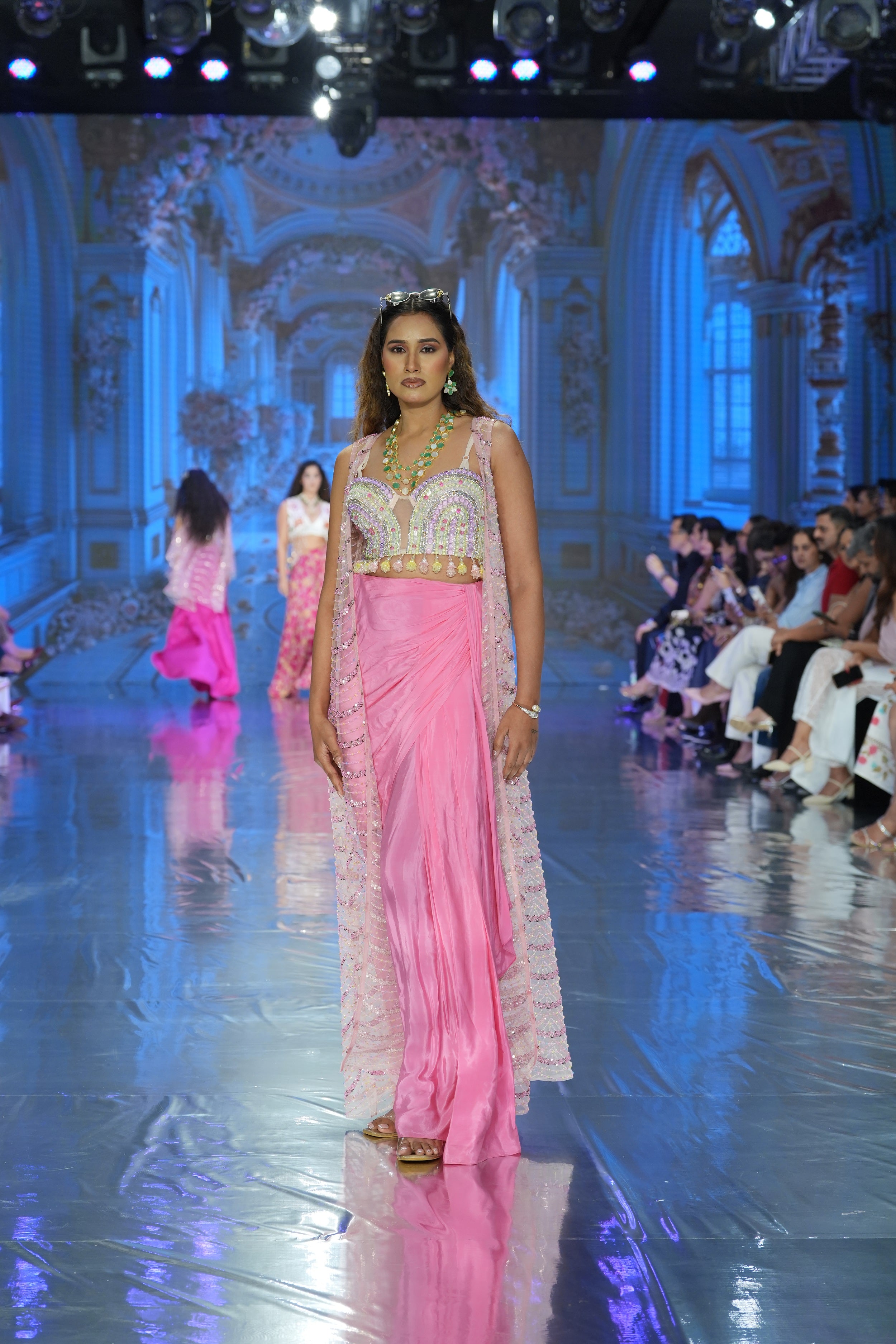 Pleated skirt with embroidered blouse and jacket
