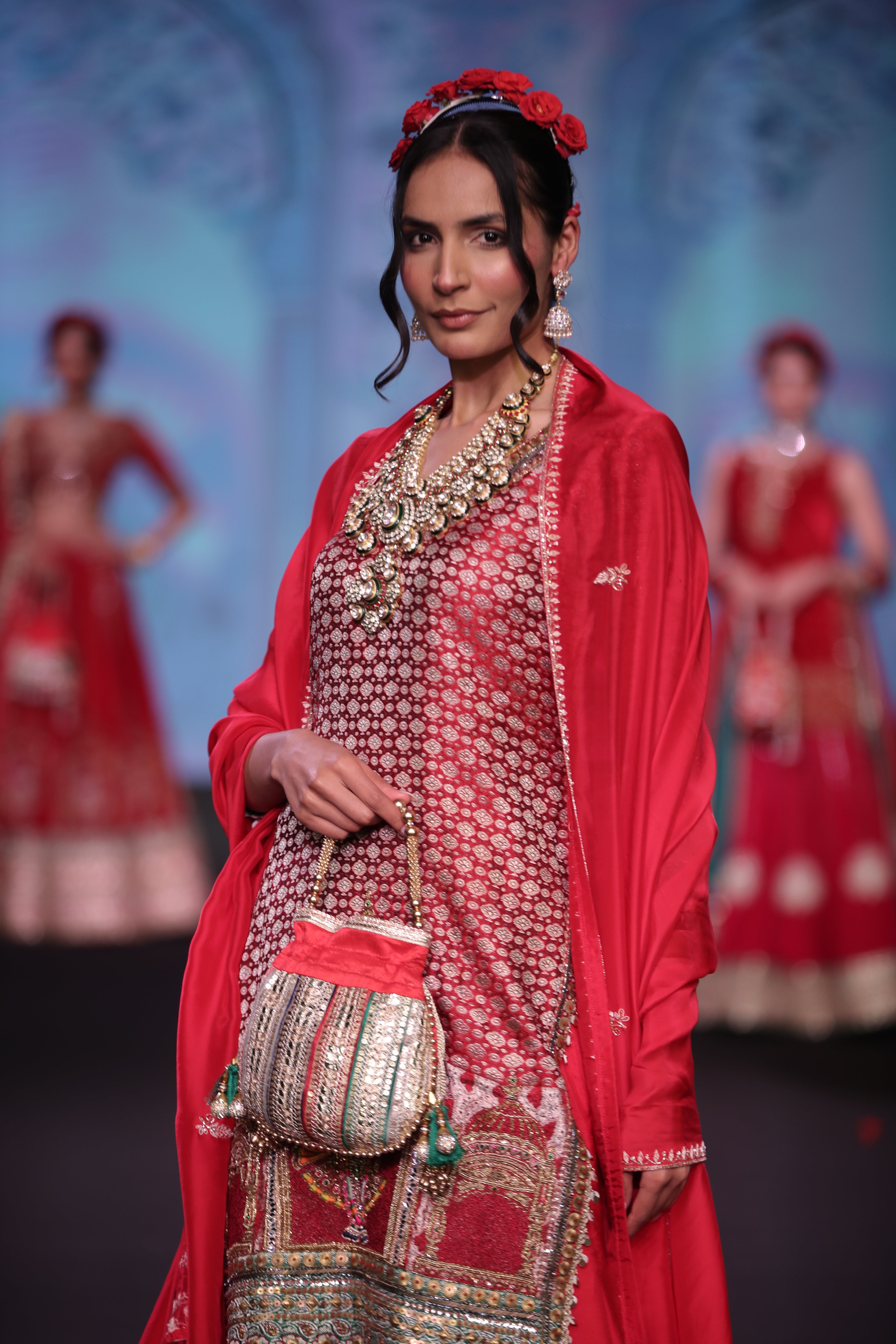 Red embroidered kurta and lehenga set with srinathji motif