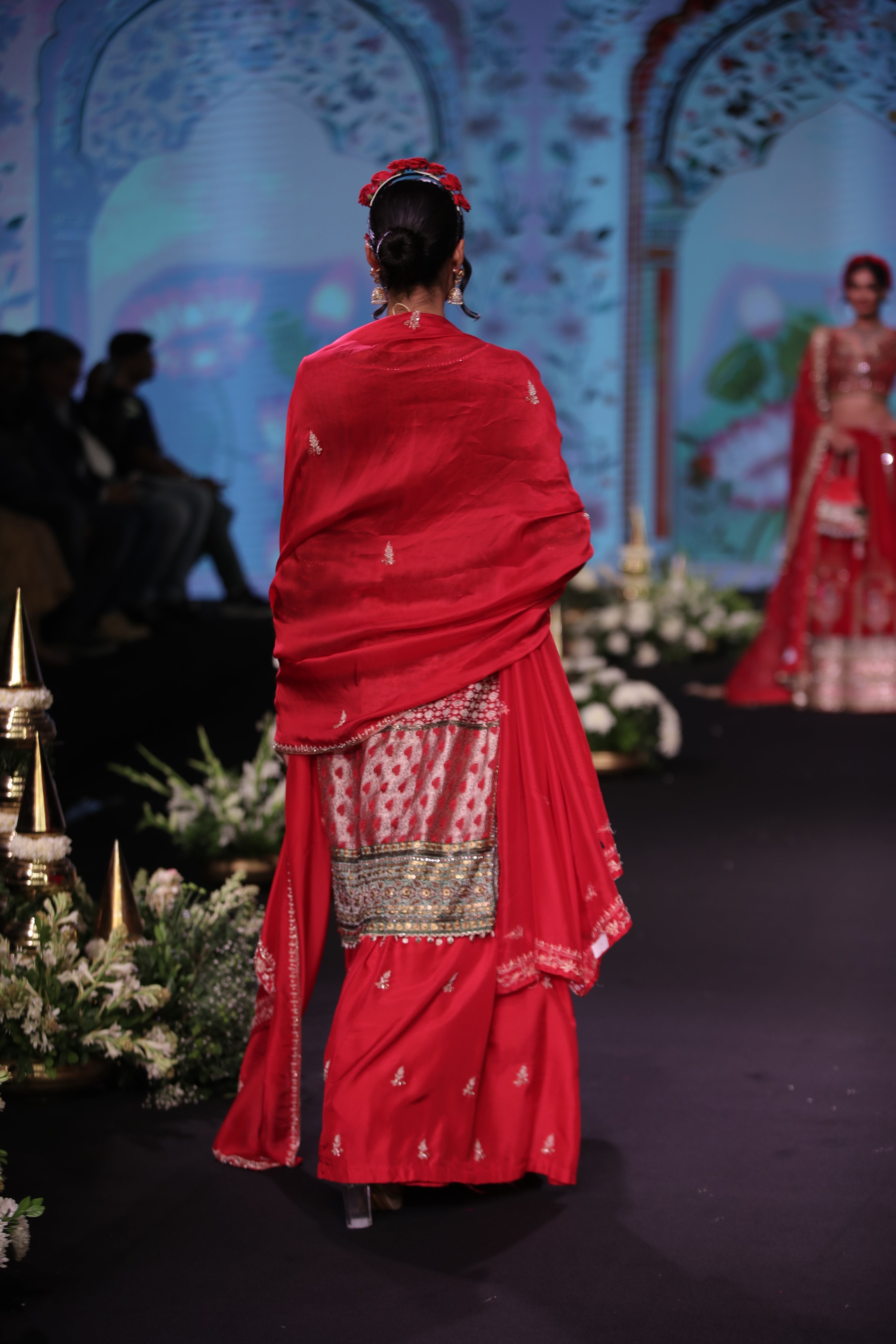Red embroidered kurta and lehenga set with srinathji motif
