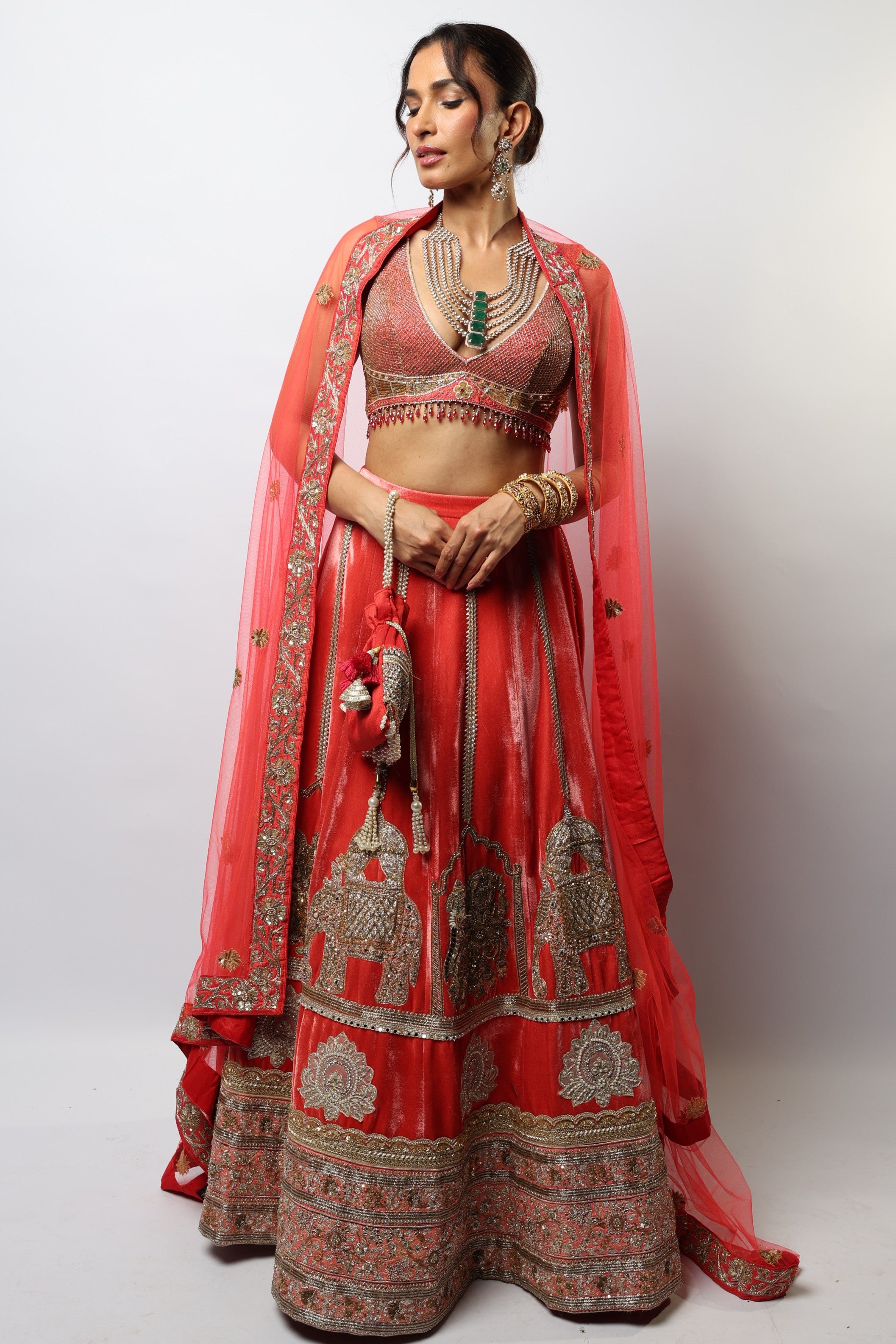 Dark orange lehenga set with embroidered motif and applique work