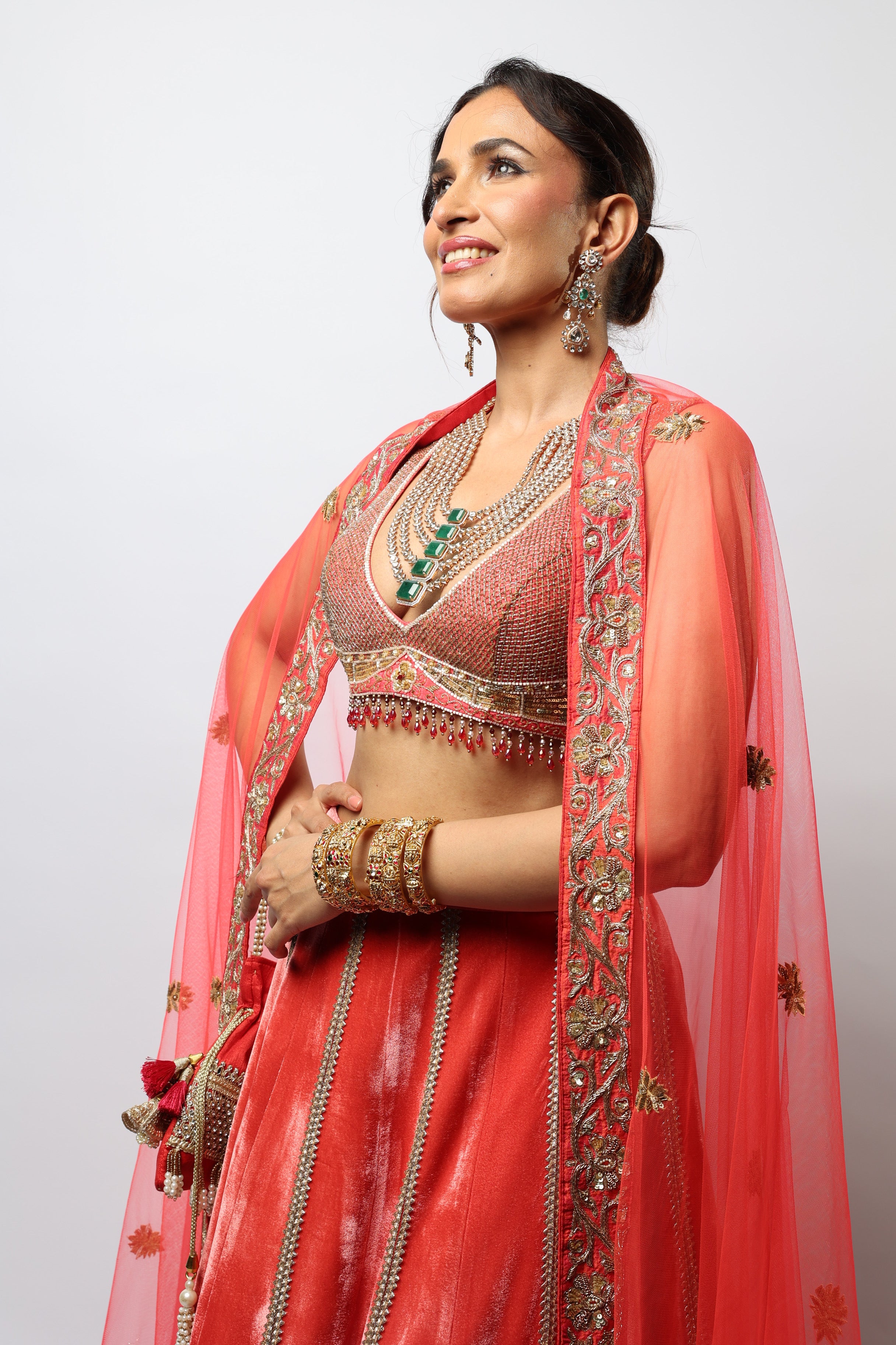 Dark orange lehenga set with embroidered motif and applique work