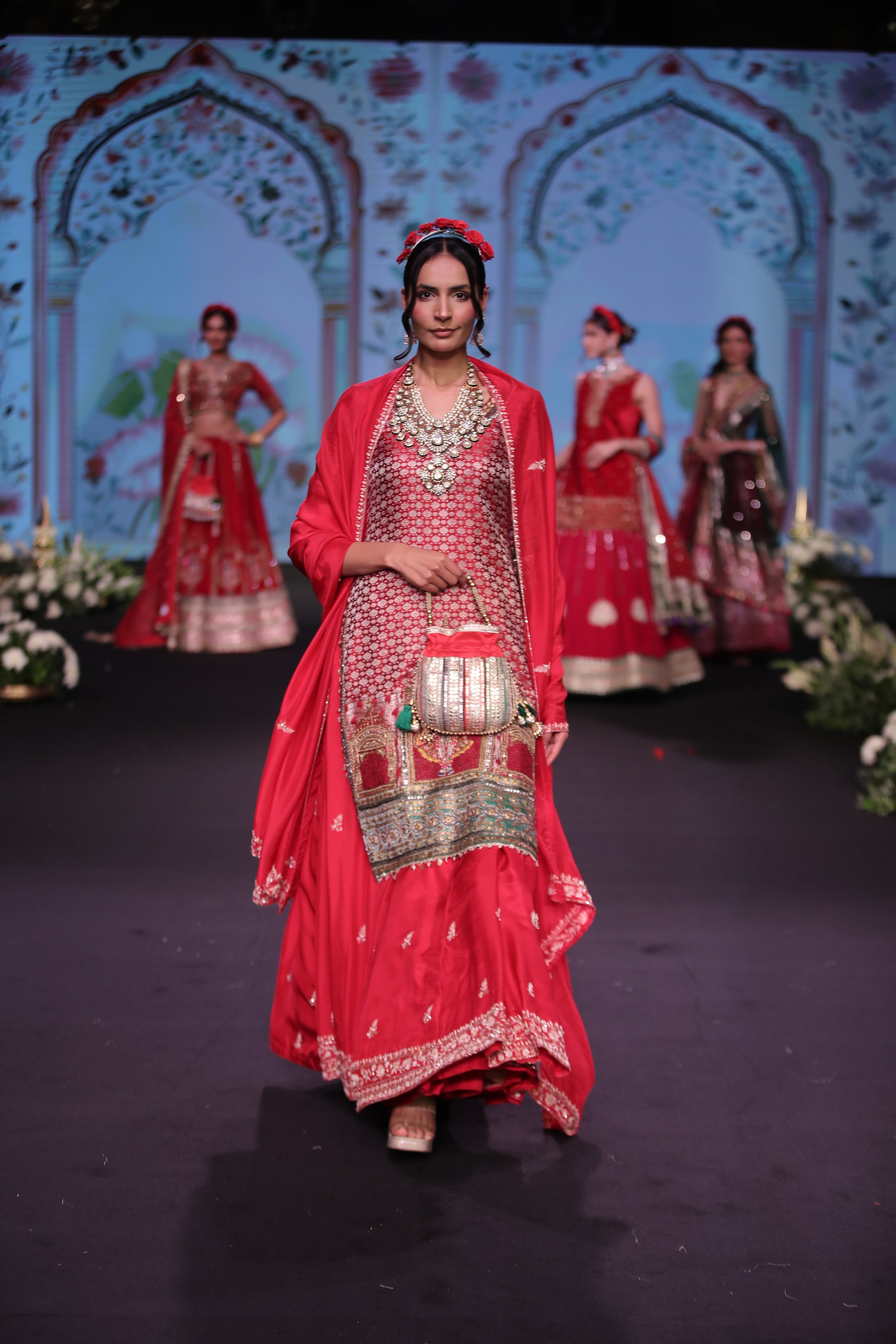 Red embroidered kurta and lehenga set with srinathji motif