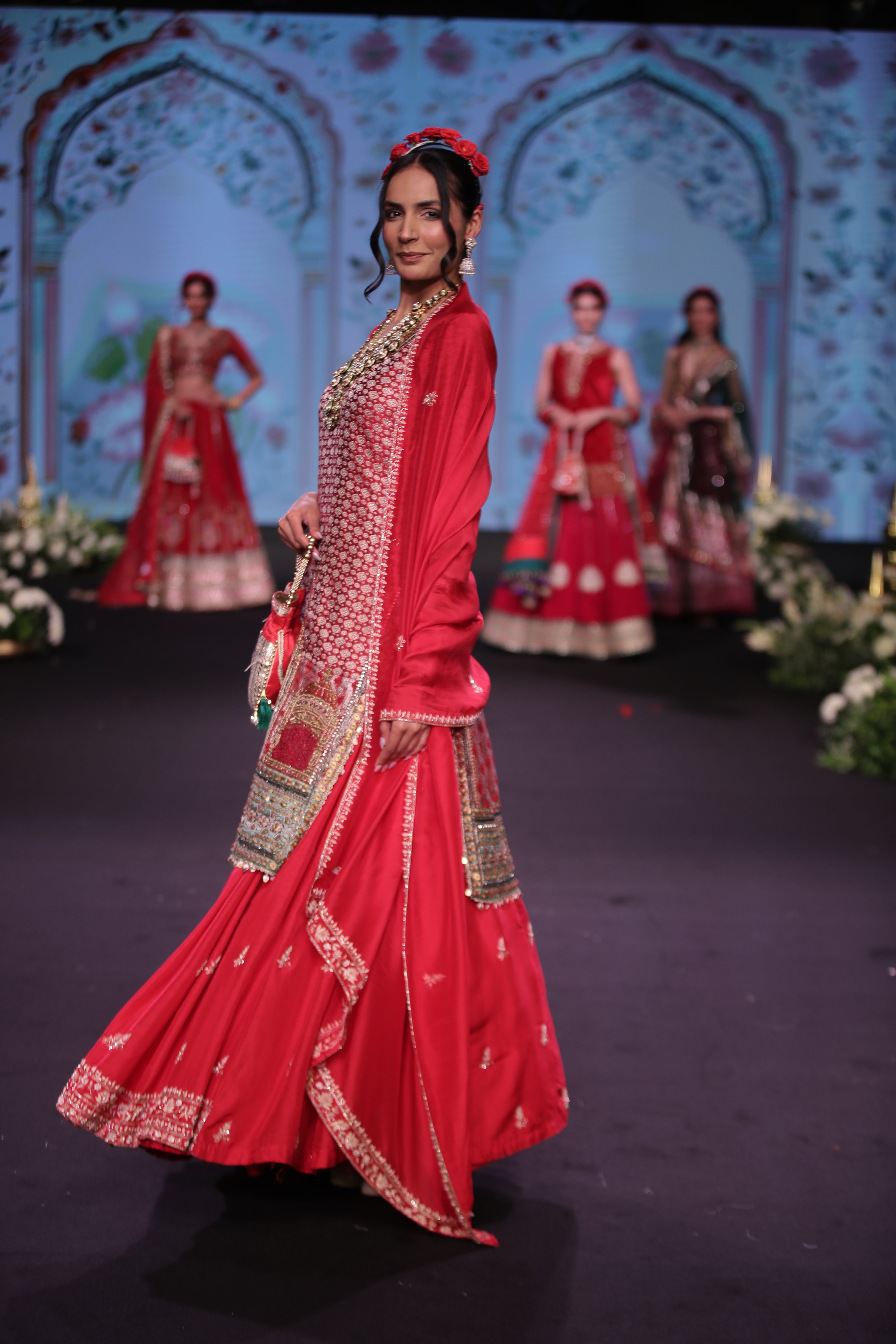 Red embroidered kurta and lehenga set with srinathji motif
